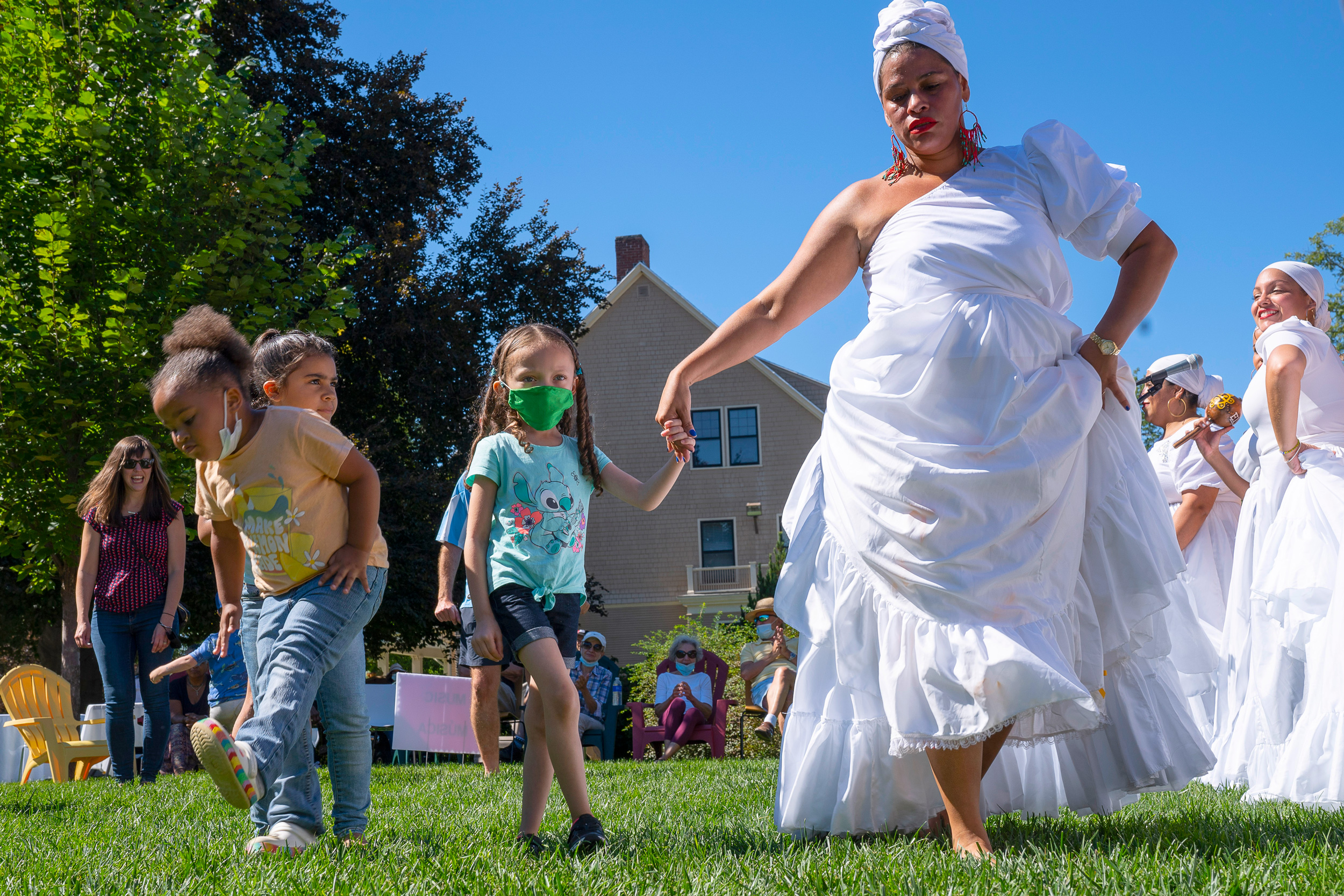 woman latin dancing and holding hands with a child