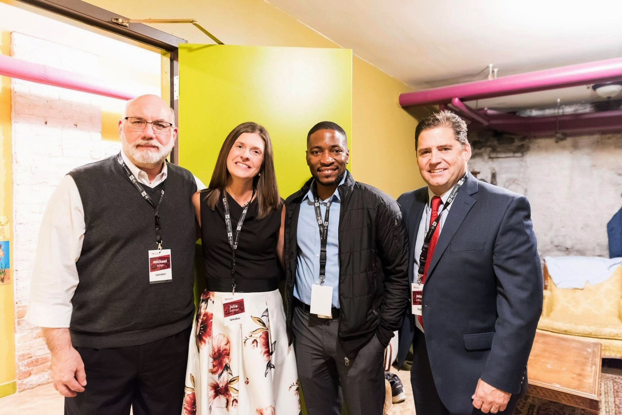 four speakers standing together