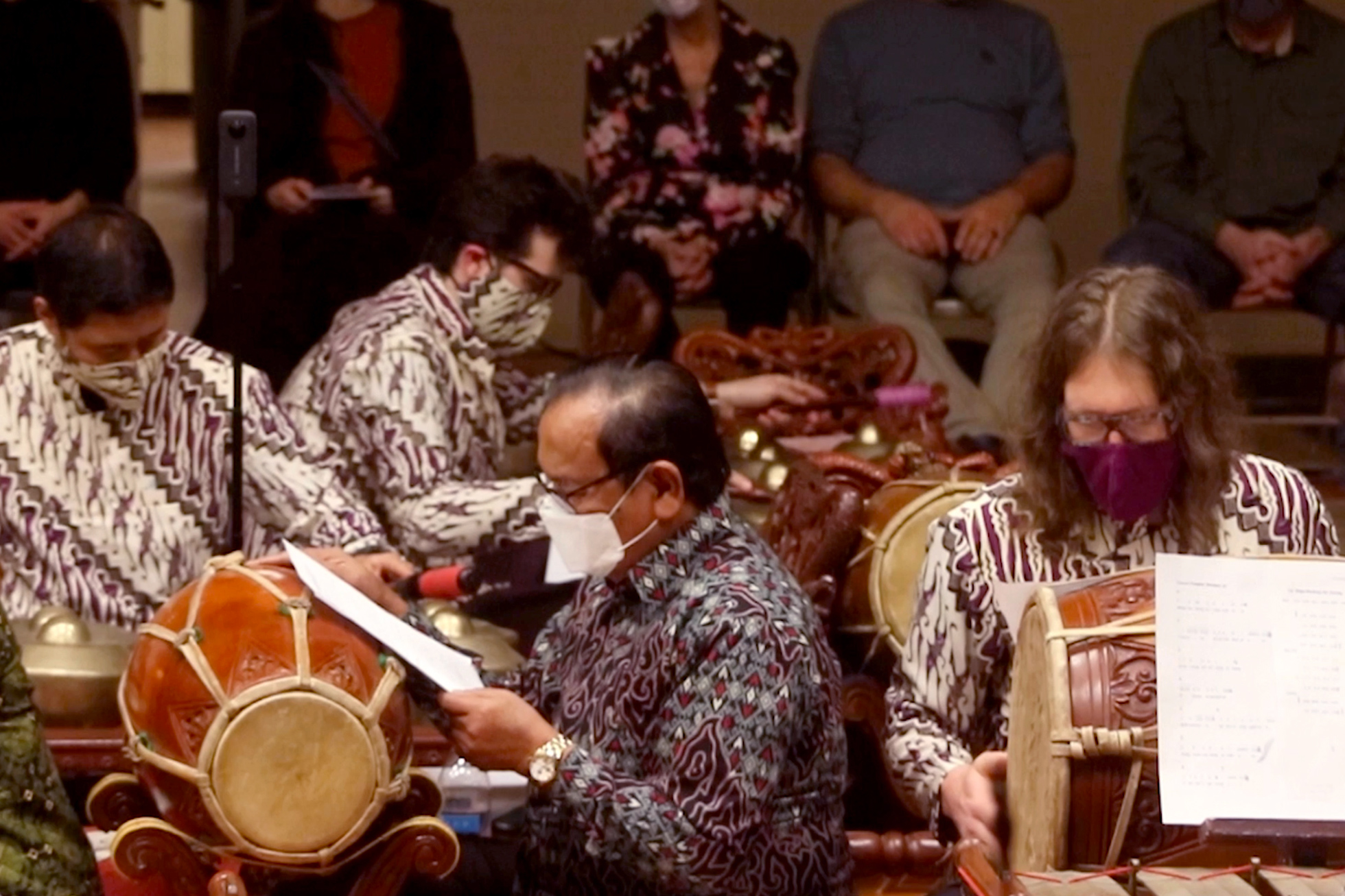 people reading Gamelan music and playing instruments