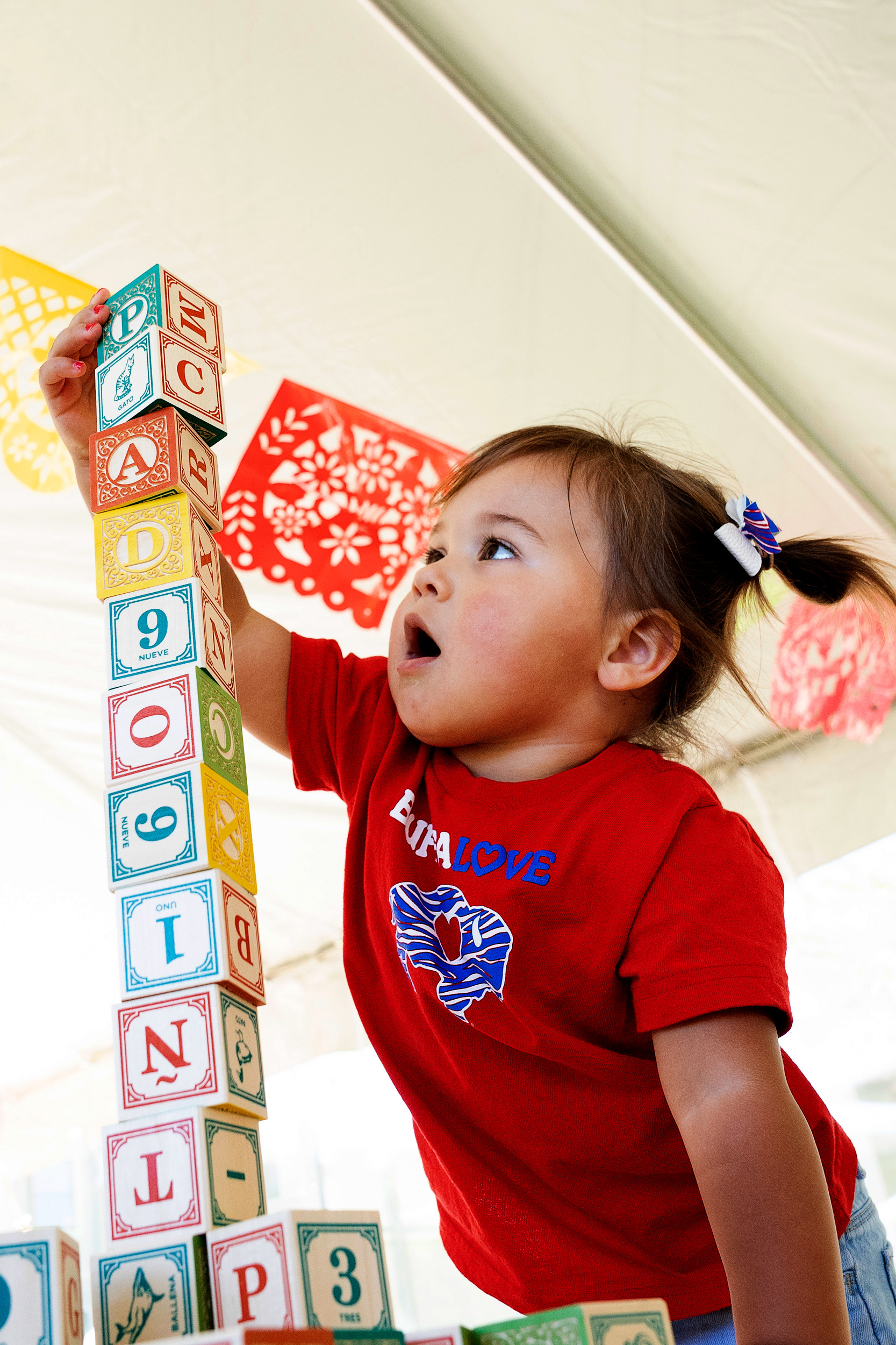 little girl playing with wooden blocks